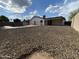 Backyard with low-maintenance gravel landscaping with pool and covered patio at 5539 W Wilshire Dr, Phoenix, AZ 85035