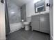 Updated bathroom with modern vanity and tiled shower-tub combo at 5539 W Wilshire Dr, Phoenix, AZ 85035