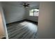 Bright bedroom with wood-look floors and a large window at 5539 W Wilshire Dr, Phoenix, AZ 85035
