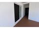 Bright entryway with white brick walls, a black front door, and a sliding glass door, creating a welcoming entrance at 5539 W Wilshire Dr, Phoenix, AZ 85035
