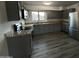 Modern kitchen with gray cabinets, granite countertops, and stainless steel appliances at 5539 W Wilshire Dr, Phoenix, AZ 85035