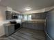Updated kitchen featuring stainless steel appliances, grey cabinets and granite countertops at 5539 W Wilshire Dr, Phoenix, AZ 85035