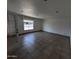 Bright living room with large window and tile flooring at 5539 W Wilshire Dr, Phoenix, AZ 85035