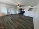 Open-concept living room with new flooring and a view into the kitchen at 5539 W Wilshire Dr, Phoenix, AZ 85035