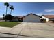 Charming single-story home with a red tile roof, green lawn, and a spacious two-car garage at 5709 E Fox St, Mesa, AZ 85205