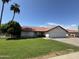 Lovely single-story home with a well-maintained lawn and a convenient two-car garage at 5709 E Fox St, Mesa, AZ 85205