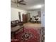 Spacious living area with tile floors, a ceiling fan, and a leather sofa at 6226 W Citrus Way, Glendale, AZ 85301