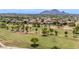 Overhead view of a residential area near a golf course, featuring beautiful homes and green spaces with mountain views at 6597 N 79Th Pl, Scottsdale, AZ 85250
