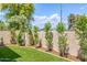 Backyard with a well-maintained lawn, manicured landscaping and desert plants at 6597 N 79Th Pl, Scottsdale, AZ 85250