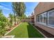 Landscaped backyard with artificial turf and perimeter planting offering a serene outdoor space at 6597 N 79Th Pl, Scottsdale, AZ 85250