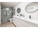 Modern bathroom featuring double vanity with quartz countertops and glass-enclosed shower at 6597 N 79Th Pl, Scottsdale, AZ 85250