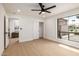 Light-filled bedroom with a ceiling fan, hardwood floors and a view of the exterior at 6597 N 79Th Pl, Scottsdale, AZ 85250