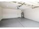 Spacious two-car garage with epoxy flooring, overhead storage, and a water heater at 6597 N 79Th Pl, Scottsdale, AZ 85250