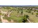 Scenic aerial view of a golf course, showcasing well-manicured greens and mature trees amidst a residential community at 6597 N 79Th Pl, Scottsdale, AZ 85250