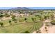 Aerial view of a golf course with manicured greens, mature trees, and a residential community in the background at 6597 N 79Th Pl, Scottsdale, AZ 85250