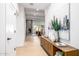 Hallway view leads to a living room with fireplace, wet bar, and outdoor access, complemented by stylish decor at 6597 N 79Th Pl, Scottsdale, AZ 85250