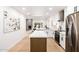 Open-concept kitchen with modern appliances, island with countertop, and bright natural light at 6597 N 79Th Pl, Scottsdale, AZ 85250