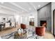 Bright living room boasts fireplace, bar, modern furnishings, and elegant dining area, creating a cozy and sophisticated ambiance at 6597 N 79Th Pl, Scottsdale, AZ 85250