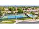 Aerial view of a community tennis court and pool surrounded by lush landscaping and homes at 6597 N 79Th Pl, Scottsdale, AZ 85250