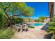 Backyard dining area with outdoor seating and a pool featuring water feature at 6996 E Mighty Saguaro Way, Scottsdale, AZ 85266