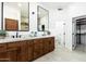 Elegant bathroom features double vanities, mirrors, and direct access to the walk-in closet at 6996 E Mighty Saguaro Way, Scottsdale, AZ 85266