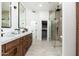 Modern bathroom with double vanity, walk-in shower, and convenient storage at 6996 E Mighty Saguaro Way, Scottsdale, AZ 85266