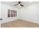A bright bedroom with wood floors and plantation shutters, illuminated by modern lighting at 6996 E Mighty Saguaro Way, Scottsdale, AZ 85266