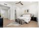 Bright bedroom featuring a plush bed, ensuite bathroom, and stylish ceiling fan at 6996 E Mighty Saguaro Way, Scottsdale, AZ 85266