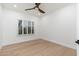 Bright bedroom with wood floors, a ceiling fan, and plantation shutters for natural light at 6996 E Mighty Saguaro Way, Scottsdale, AZ 85266