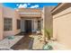 Picturesque courtyard with desert landscaping, a stone walkway, and a tranquil seating area near the front door at 6996 E Mighty Saguaro Way, Scottsdale, AZ 85266