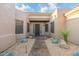 Front entrance featuring gravel, stones, plants, and decorative metalwork at 6996 E Mighty Saguaro Way, Scottsdale, AZ 85266