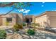Inviting home with desert landscaping and a quaint front entry, showcasing a well-maintained exterior at 6996 E Mighty Saguaro Way, Scottsdale, AZ 85266