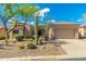Charming single-story home featuring desert landscaping, native plants, and an attached two-car garage at 6996 E Mighty Saguaro Way, Scottsdale, AZ 85266