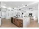 Open floor plan featuring a kitchen with a kitchen island, stainless steel appliances, and a living area at 6996 E Mighty Saguaro Way, Scottsdale, AZ 85266