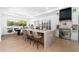 Bright kitchen featuring stainless steel appliances, kitchen island with bar stools, and adjacent dining area at 6996 E Mighty Saguaro Way, Scottsdale, AZ 85266