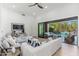 Open living room featuring modern decor, light wood flooring, and seamless indoor-outdoor flow to the pool at 6996 E Mighty Saguaro Way, Scottsdale, AZ 85266
