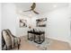 Modern office with wood floors, a ceiling fan, and a desk with artwork at 6996 E Mighty Saguaro Way, Scottsdale, AZ 85266