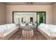Charming outdoor patio with comfortable seating overlooking the bright, inviting interior living room at 6996 E Mighty Saguaro Way, Scottsdale, AZ 85266