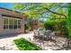 Backyard dining area featuring outdoor seating, lush landscaping, and covered patio at 6996 E Mighty Saguaro Way, Scottsdale, AZ 85266