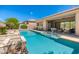 Backyard swimming pool featuring water feature, lounge seating and backyard desert landscaping at 6996 E Mighty Saguaro Way, Scottsdale, AZ 85266