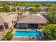 Inviting backyard oasis featuring sparkling rectangular pool, patio seating, and convenient access from the home's interior at 6996 E Mighty Saguaro Way, Scottsdale, AZ 85266