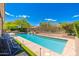 Backyard pool featuring water feature, poolside seating, and desert landscaping at 6996 E Mighty Saguaro Way, Scottsdale, AZ 85266