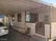 Exterior side view of home with covered parking, slider entrance, and a small patio at 701 S Dobson Rd # 438, Mesa, AZ 85202