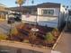Charming single story home featuring manicured flower beds and a covered parking area at 701 S Dobson Rd # 438, Mesa, AZ 85202