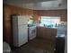Functional kitchen features wooden cabinets, white appliances, and ample counter space at 701 S Dobson Rd # 438, Mesa, AZ 85202