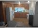 Efficient kitchen with wooden cabinets, white appliances, and functional layout at 701 S Dobson Rd # 438, Mesa, AZ 85202