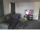 Cozy living room featuring a comfy sofa, a TV, and neutral carpet for a relaxing atmosphere at 701 S Dobson Rd # 438, Mesa, AZ 85202
