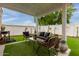 Inviting backyard with artificial turf and a shaded seating area, perfect for outdoor living at 7064 W Lincoln St, Peoria, AZ 85345