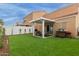 Landscaped backyard with artificial turf and a covered patio, perfect for outdoor entertaining at 7064 W Lincoln St, Peoria, AZ 85345