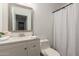Clean bathroom with a vanity, mirror, toilet, and shower featuring a patterned curtain at 7064 W Lincoln St, Peoria, AZ 85345